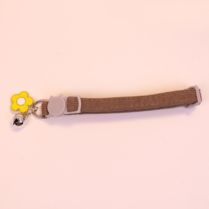 Brown cat collar with cat-face buckle, yellow flower charm and bell