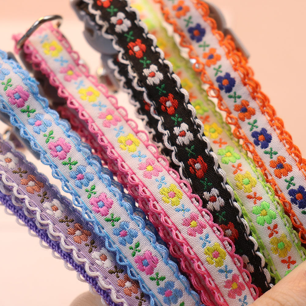 Close-up of floral collar bands with contrast scalloped trim
