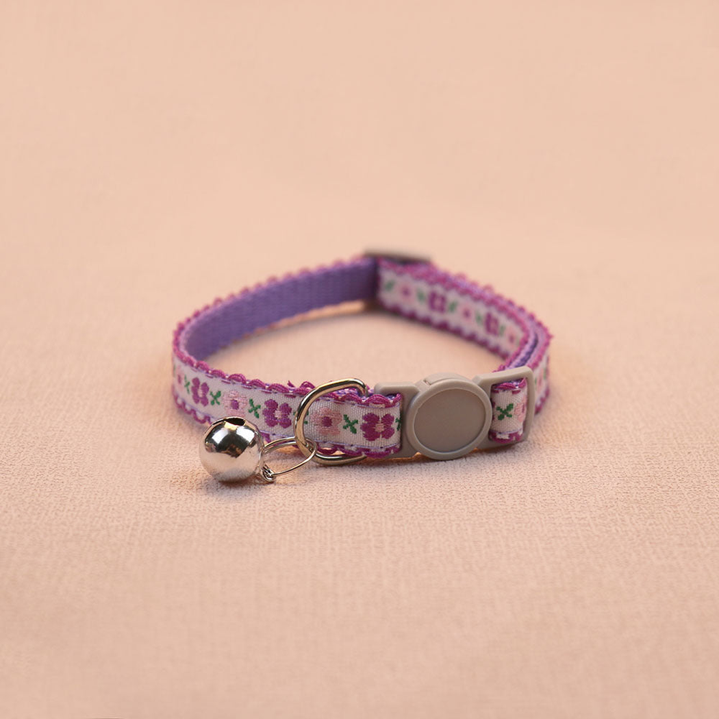 Deep purple floral cat collar with a white center band and bell