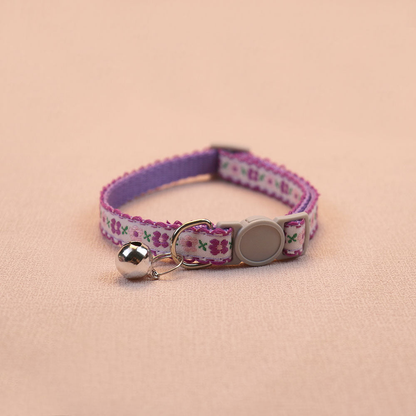 Deep purple floral cat collar with a white center band and bell