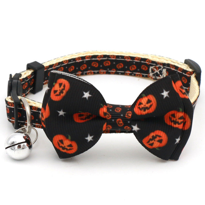 Black cat collar with small pumpkin and star-print bow and bell