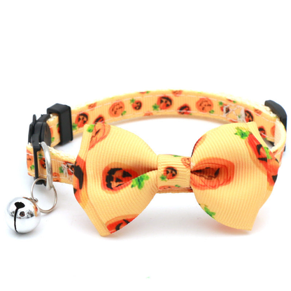 Yellow cat collar with pumpkin-print bow, green accents and bell