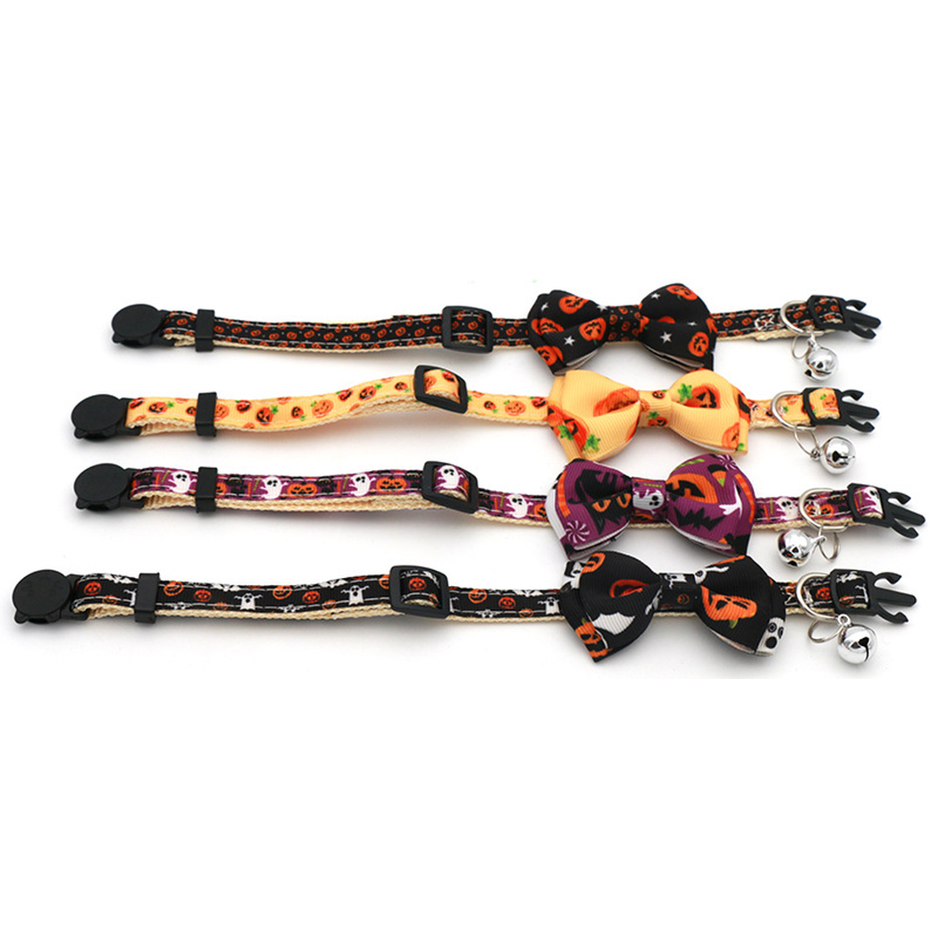 Four pumpkin-print bow cat collars laid flat to show their adjustable straps
