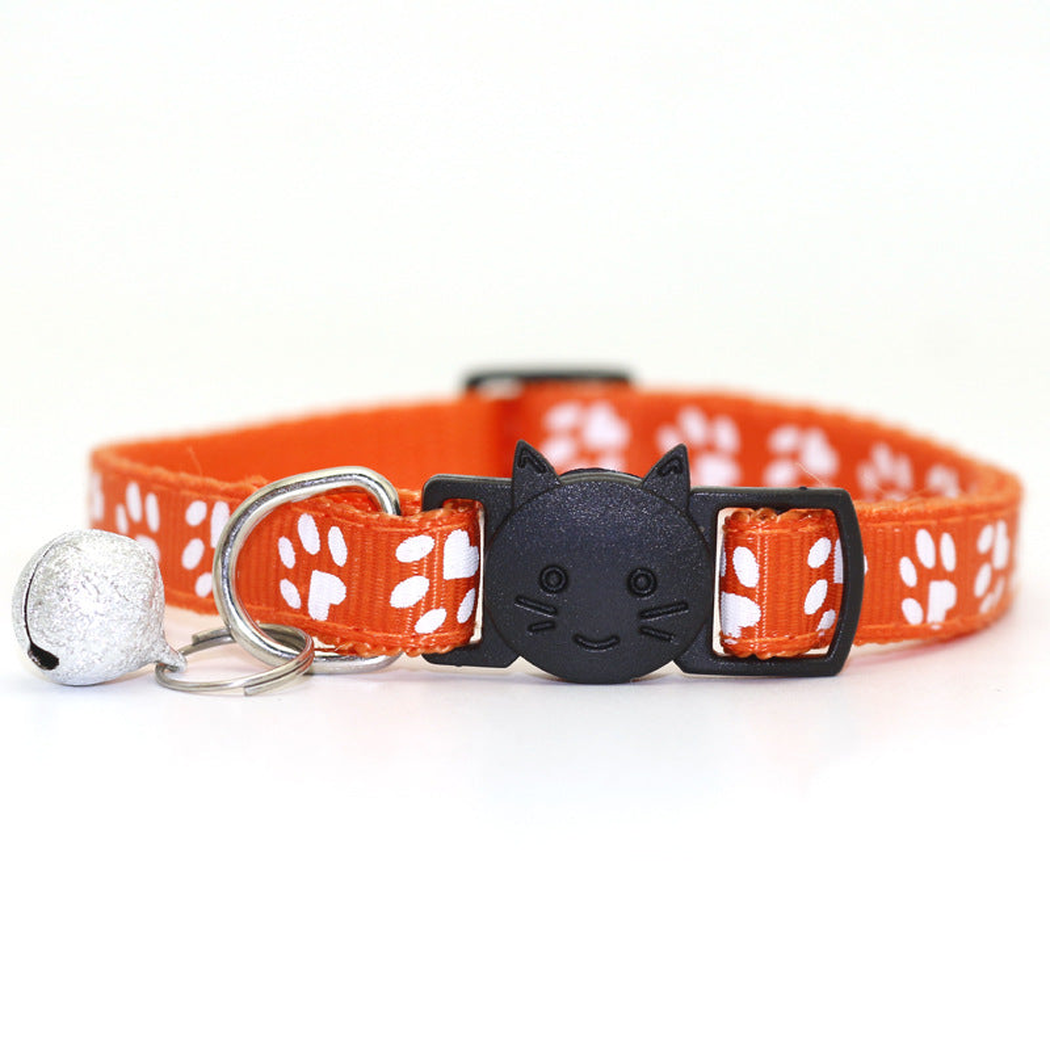 Orange paw-print cat collar with cat-face buckle and bell