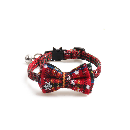 Red plaid bow cat collar with snowflake motifs and bell, front view