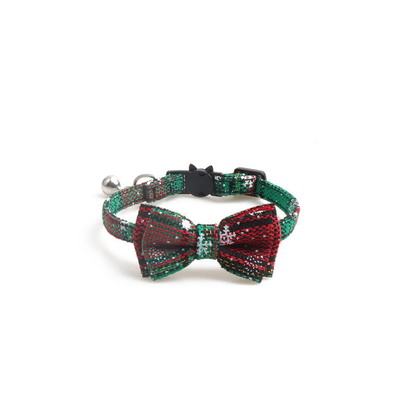 Green plaid bow cat collar with snowflake motifs and bell, front view
