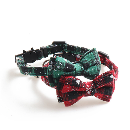 Red and green plaid bow cat collars in an angled display