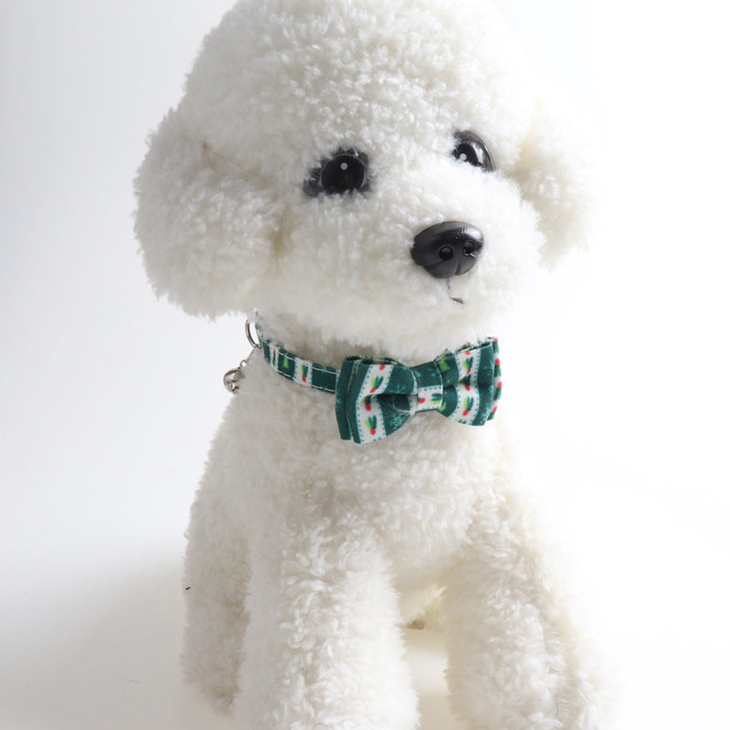 Dark green patterned bow cat collar displayed on a plush dog model