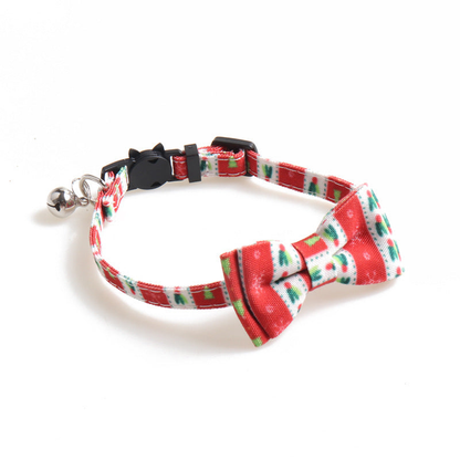 Red patterned bow cat collar angled to show the bell, buckle and adjustable strap