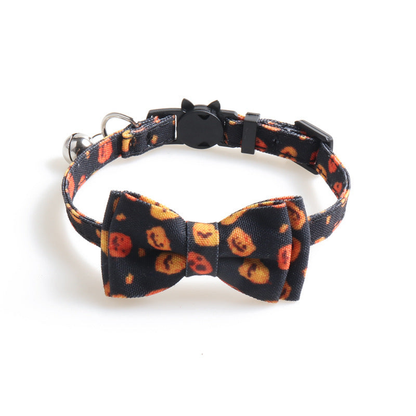 Black pumpkin-print cat collar with bow, bell and cat-face buckle