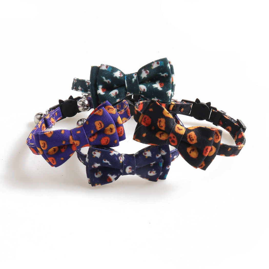 Four bow cat collars in pumpkin and ghost prints displayed together