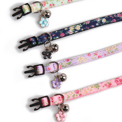 Close-up of floral collar straps with bells, flower charms and buckles
