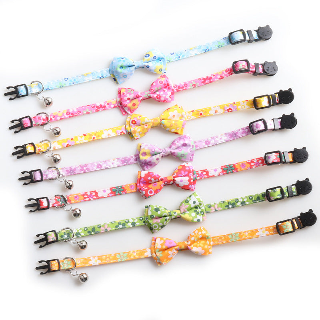 Seven floral bow cat collars in assorted colors with bells