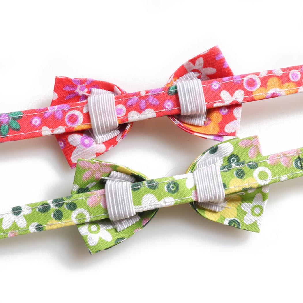 Back detail of bow attachment loops on red and green floral collars