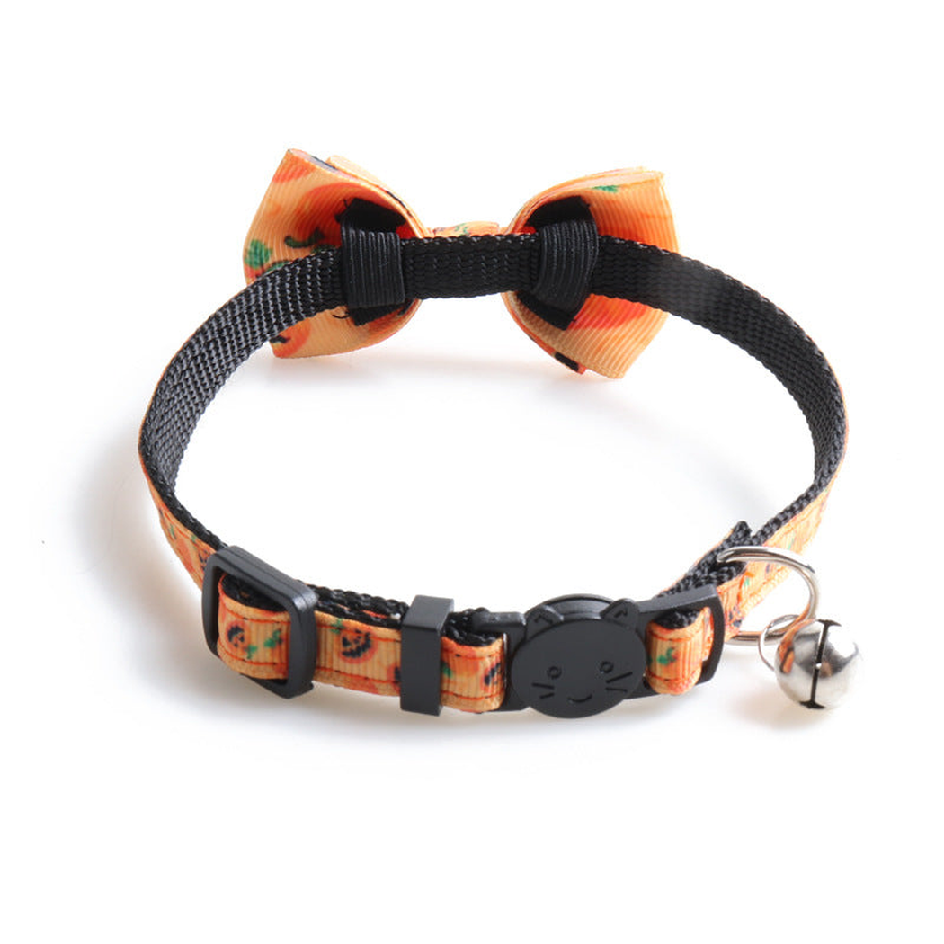 Orange pumpkin-print bow cat collar, rear view with cat-face buckle and bell
