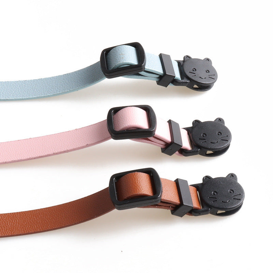 Close-up of cat-face buckles and adjustment sliders in three colors