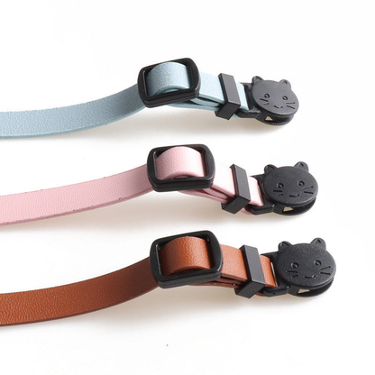 Close-up of cat-face buckles and adjustment sliders in three colors