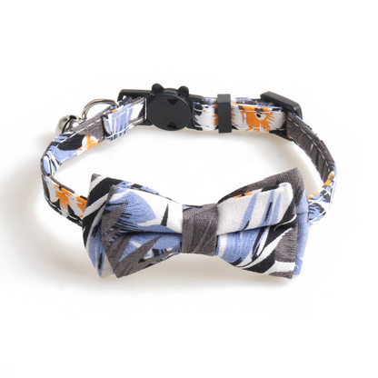 Blue-gray leaf-print cat collar with bow, bell, and cat-face buckle