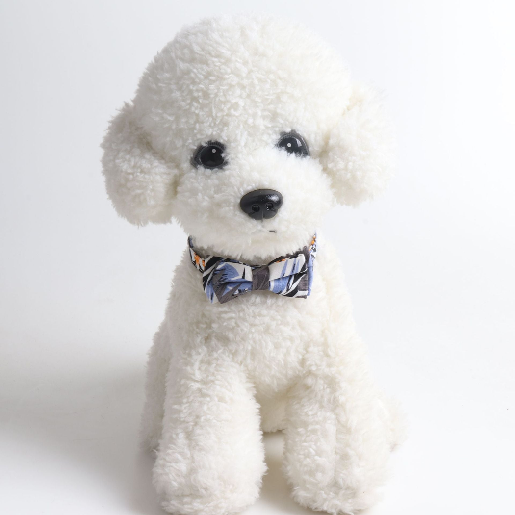Blue-gray leaf-print bow cat collar displayed around the neck of a white plush model