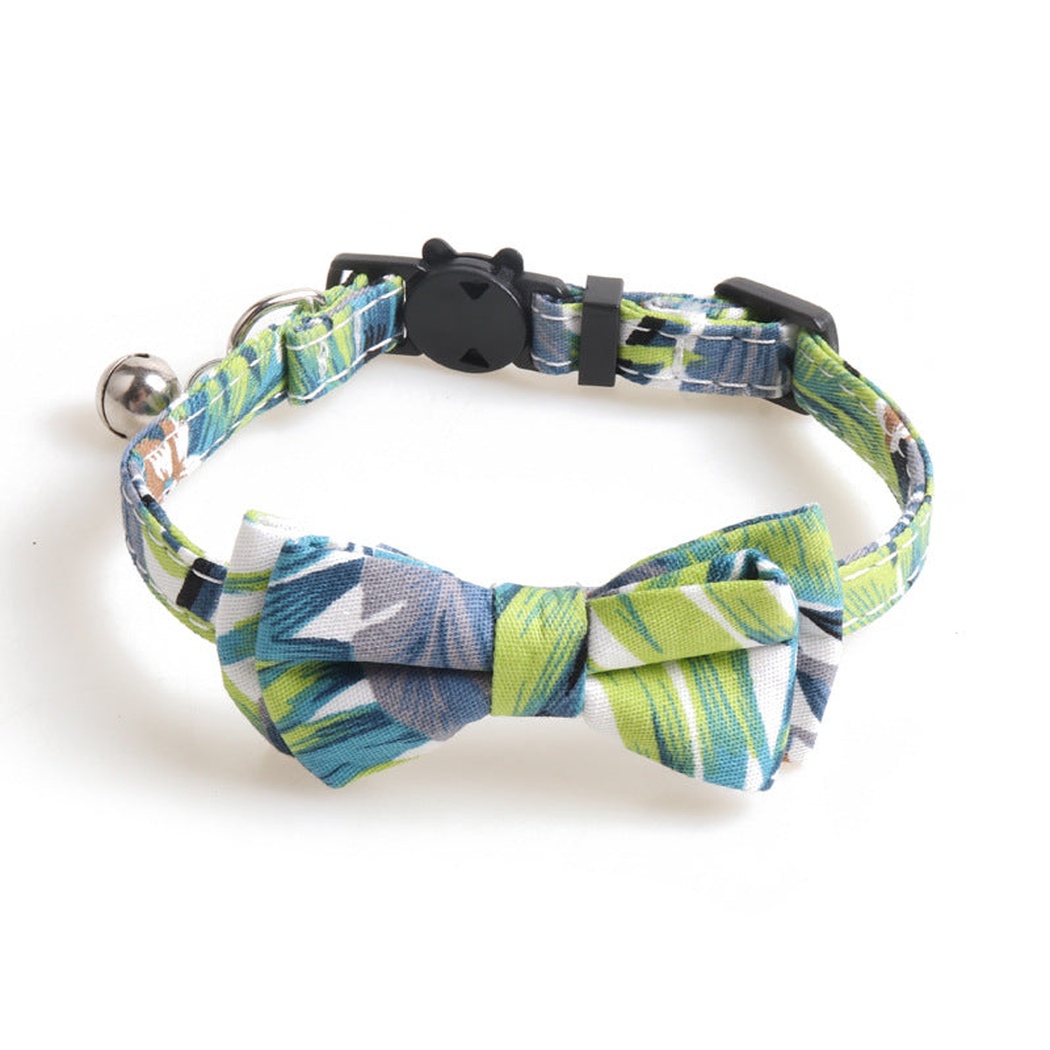 Green leaf-print cat collar with bow, bell, and cat-face buckle