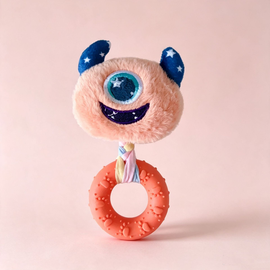 Orange one-eyed monster-face ring dog toy, front view