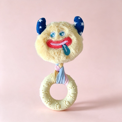 Yellow monster-face ring dog toy with an ivory ring, front view