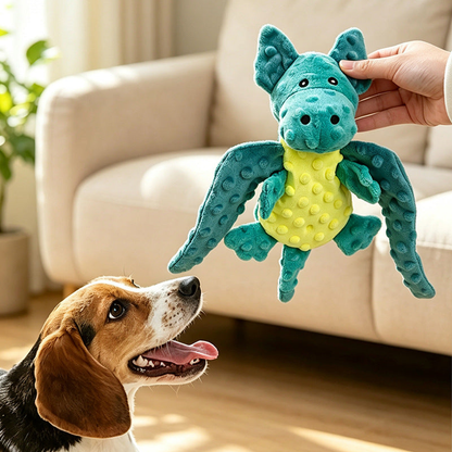 Turquoise and yellow winged dragon dog toy held above an attentive dog