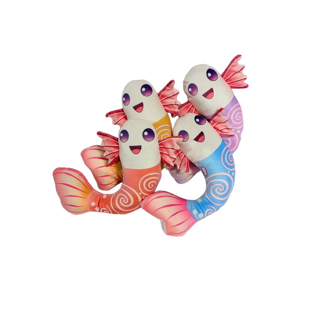 Four colorful fish-shaped dog toys grouped on a light fabric background