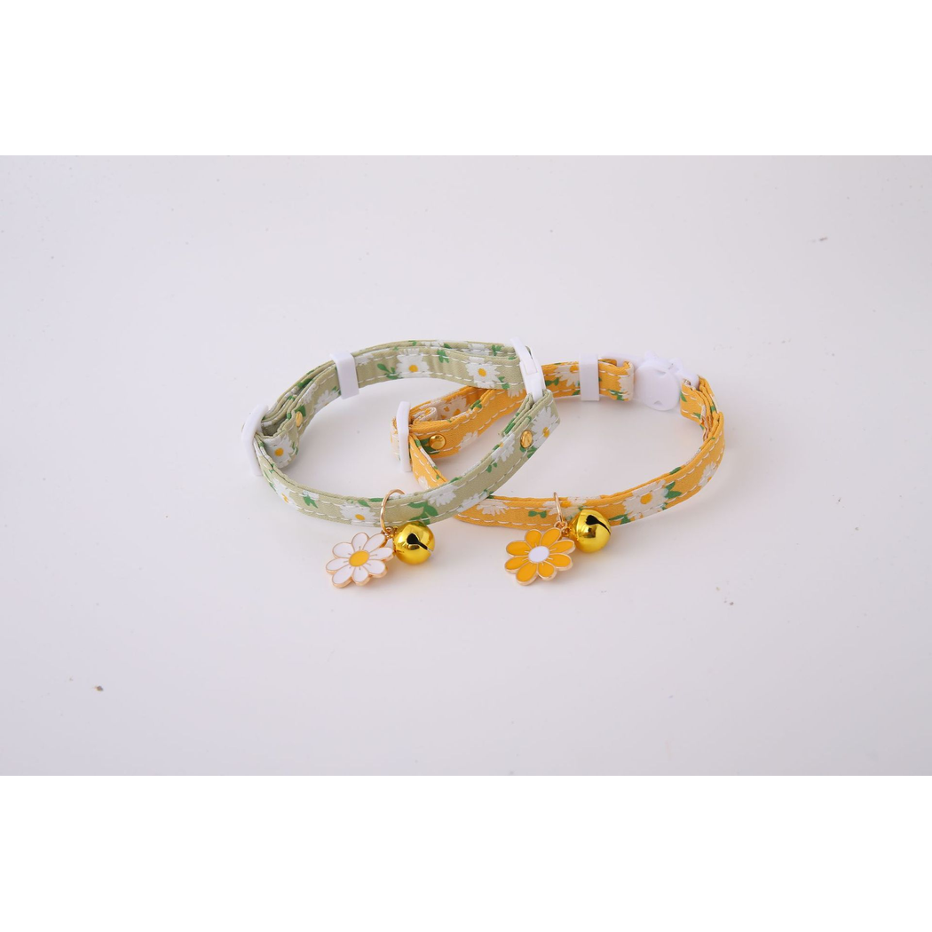 Green and mustard yellow daisy-print cat collars displayed together