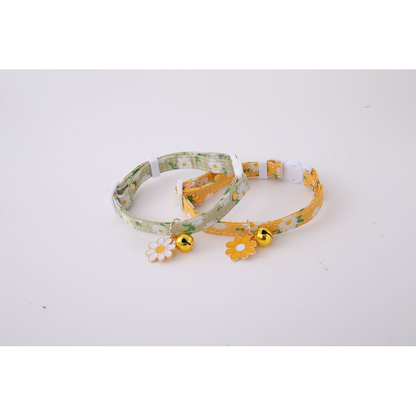 Green and mustard yellow daisy-print cat collars displayed together