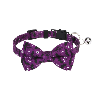 Purple Bow cat collar with bats, moons, skulls, bones, stars, and a silver-tone bell