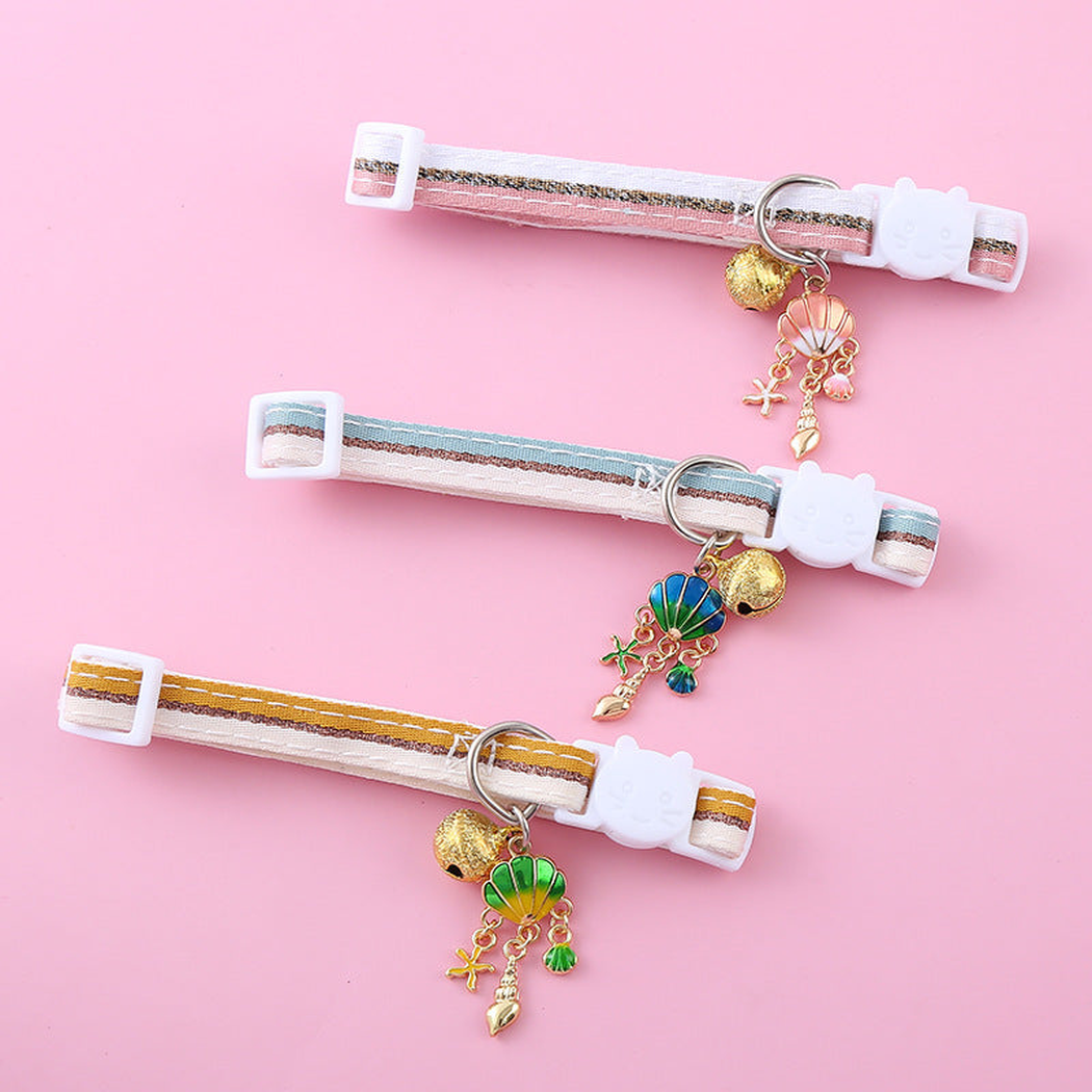 Pink, light blue and mustard yellow striped cat collars displayed together