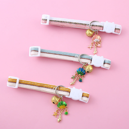 Pink, light blue and mustard yellow striped cat collars displayed together