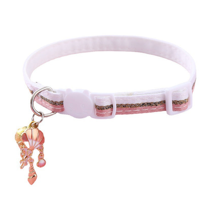 Pink striped cat collar with shell-themed charm cluster on a white background
