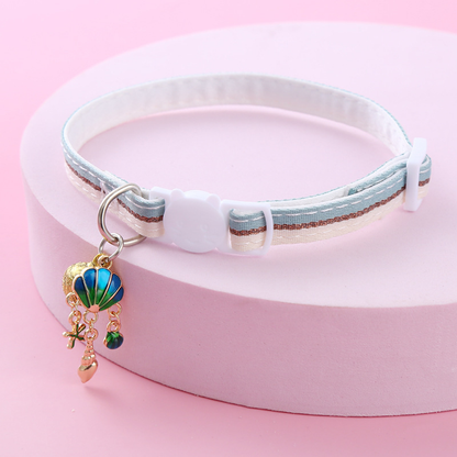 Light blue striped cat collar with white cat-face buckle, bell and shell-themed charms