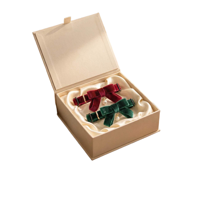 Burgundy Ribbon and Green Ribbon cat collars displayed in a presentation box