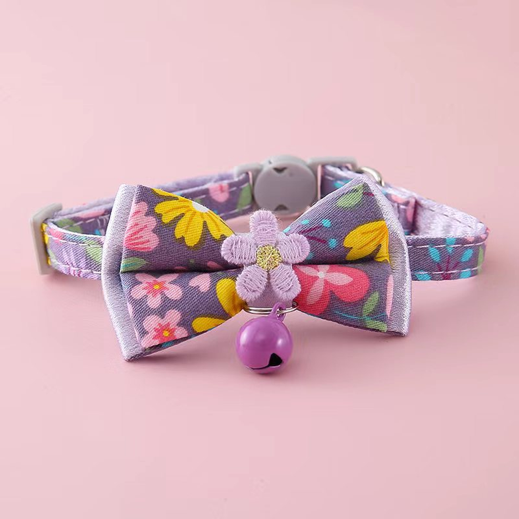 Purple floral cat collar with bow, flower accent and bell, front view