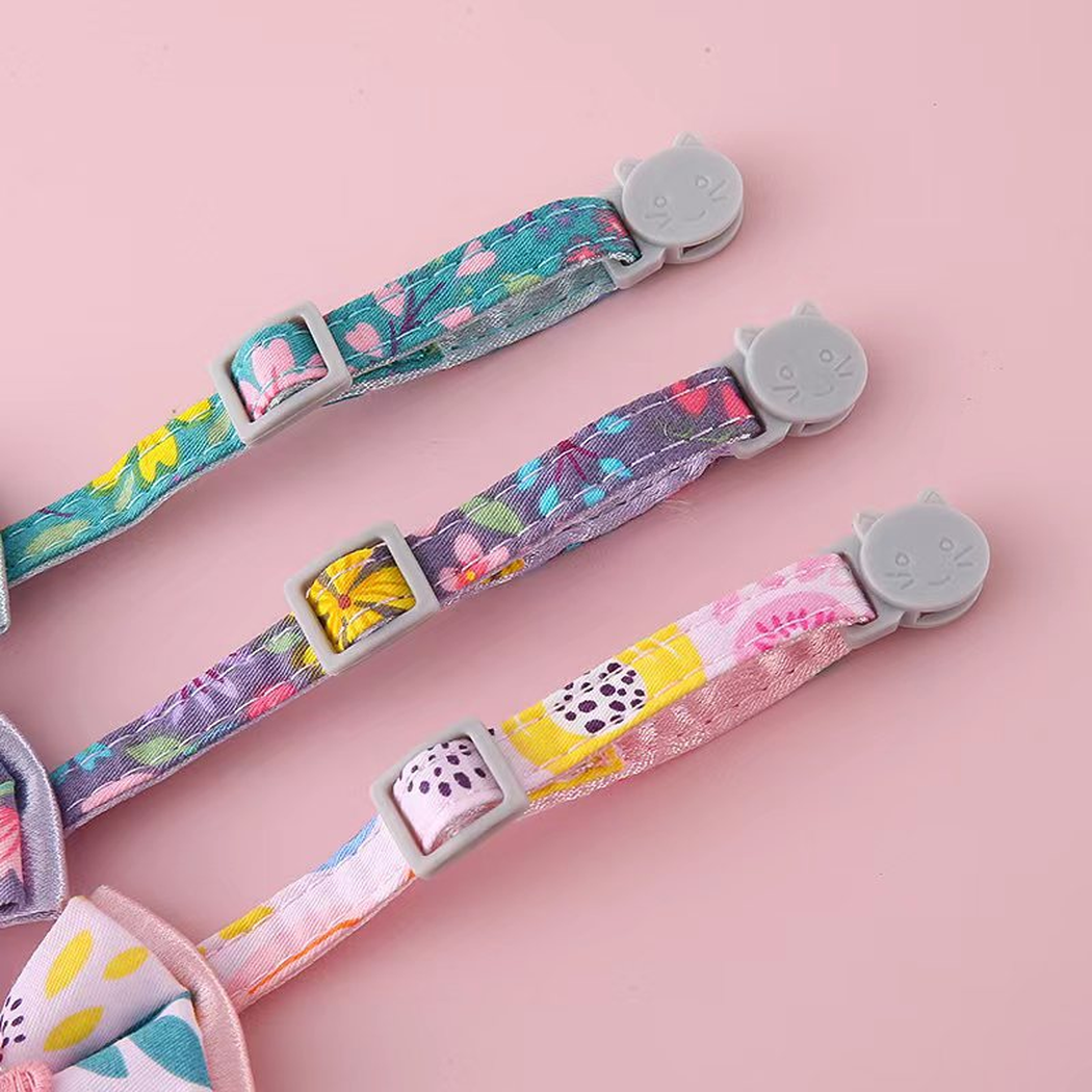 Close-up of adjustable floral collar straps and gray cat-face buckles
