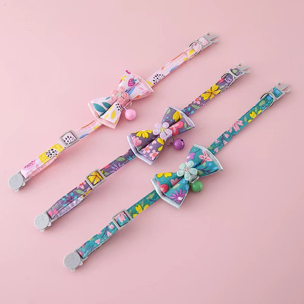 Teal Blue, Purple and Light Pink floral bow cat collars laid flat to show adjustable straps and hardware