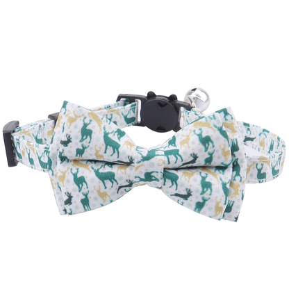 White Reindeer cat collar with green and gold-tone silhouette bow, front view