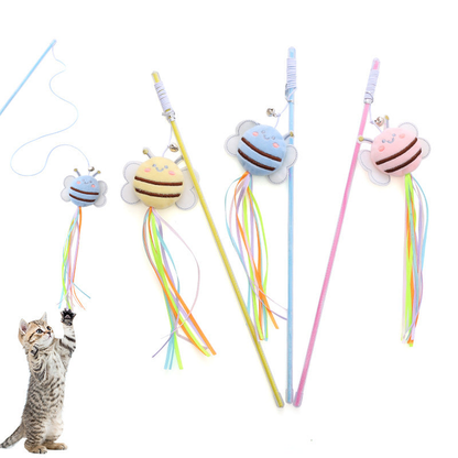 Kitten reaching toward a light blue bee wand cat toy with ribbon streamers
