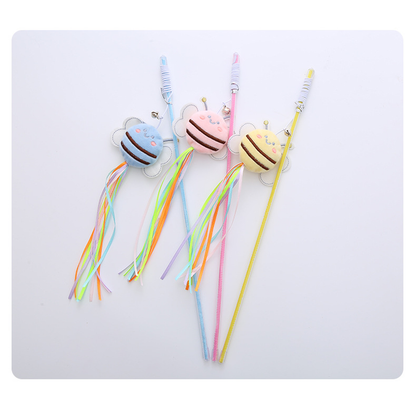 Pink, yellow, and light blue bee wand cat toys arranged together