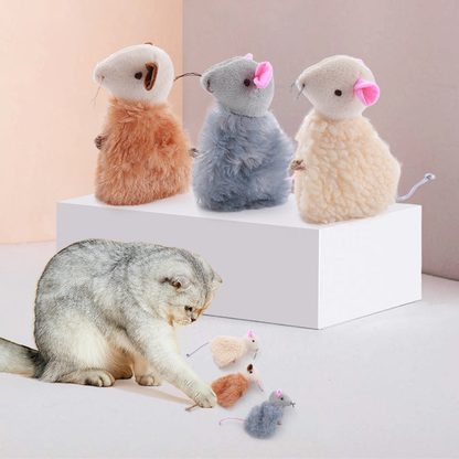 Cat playing beside beige, gray and brown mouse-shaped cat toys