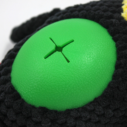 Close-up of the green belly insert with a cross-shaped opening on the Toucan toy