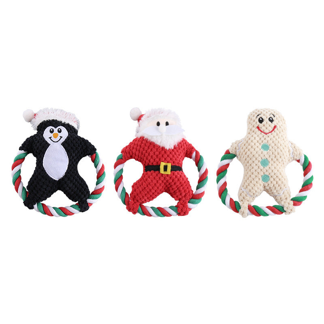 Penguin, Santa, and gingerbread character dog toys displayed together