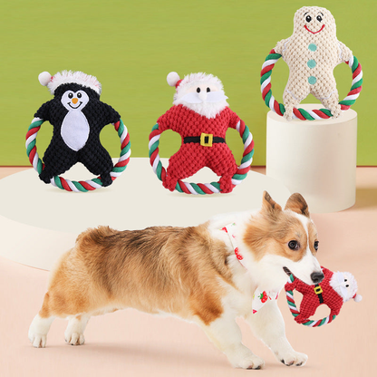 Penguin, Santa, and gingerbread character dog toys displayed with a dog holding the Santa style