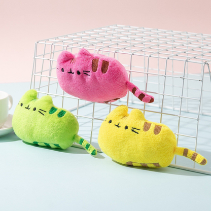 Green, pink and yellow cat-shaped toys arranged around a wire display