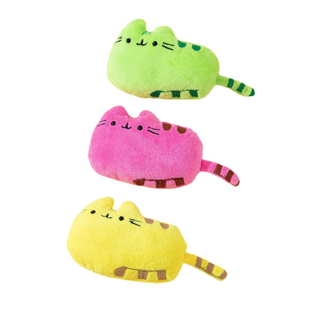 Green, pink and yellow cat-shaped toys with stitched faces and striped tails
