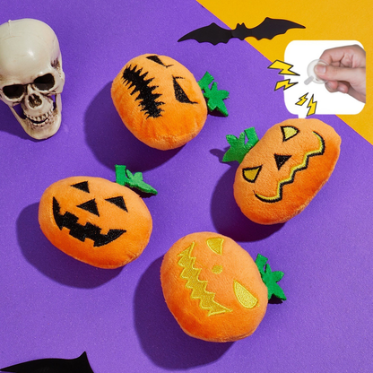 Four orange pumpkin-shaped cat toys with a squeaker insert callout on a purple Halloween backdrop