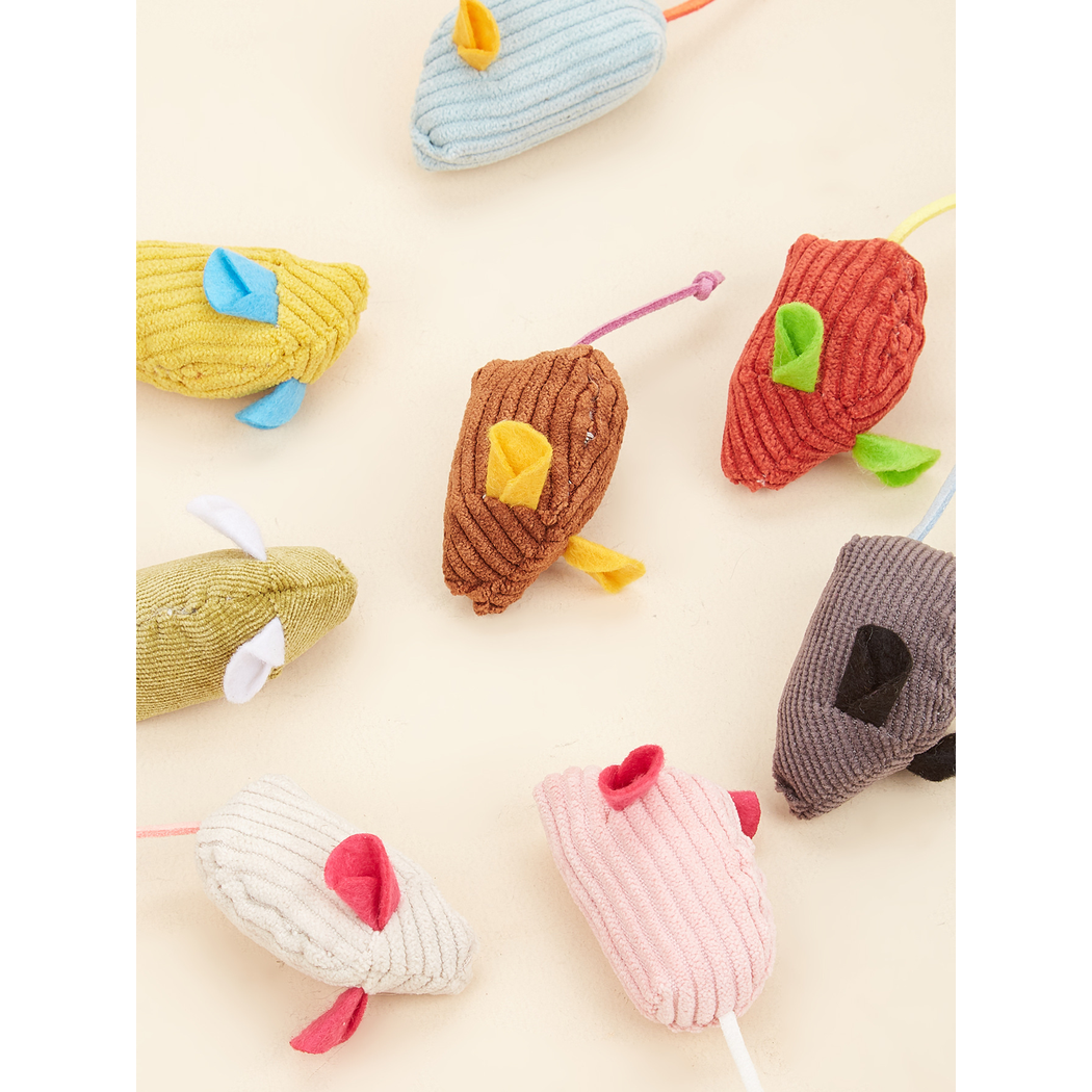 Close-up of ribbed mouse-shaped toys with contrasting ears and cord tails